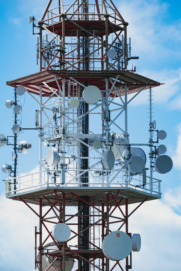 Telecommunications tower equipment against a blue sky